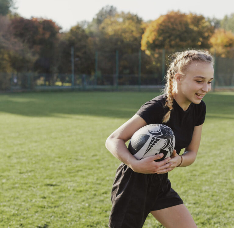 blonde-girl-running-with-rugby-ball (1) (1)