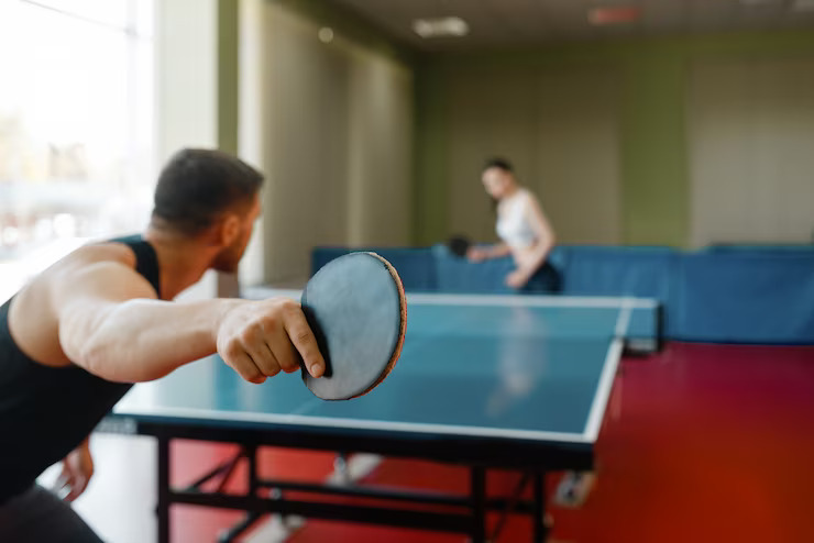 man-woman-playing-ping-pong-indoors_266732-1166