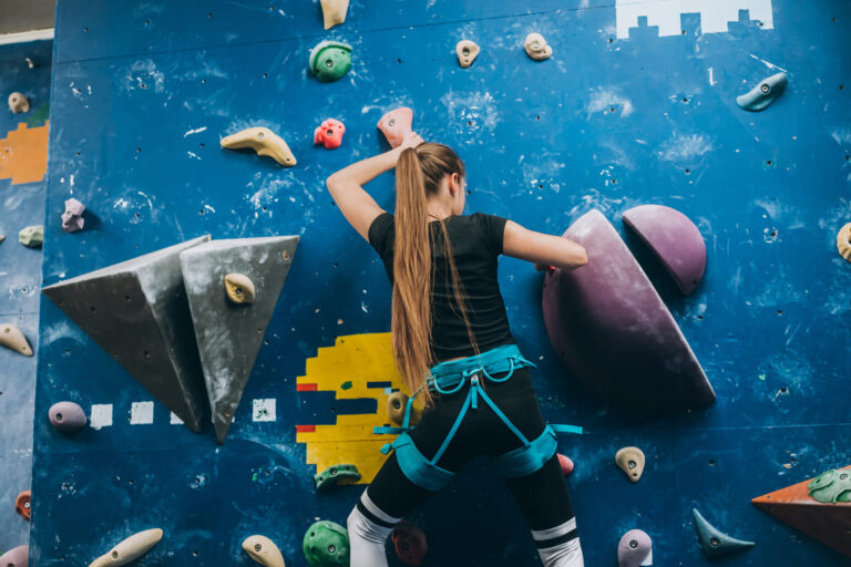 young-woman-climbing-tall-indoor-man-made-rock-climbing-wall (1) (1)